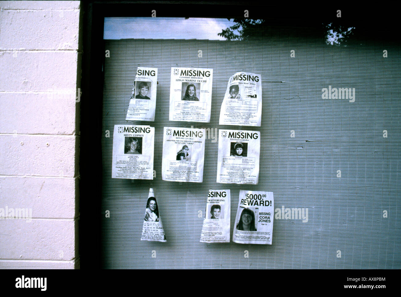 Posters for missing children in shop window in US town Stock Photo