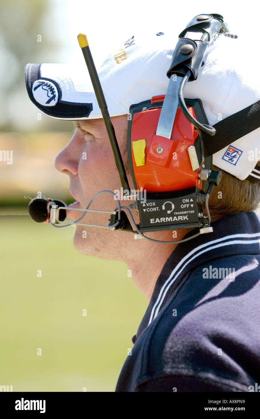 American High School Football Action coach wearing headphones to