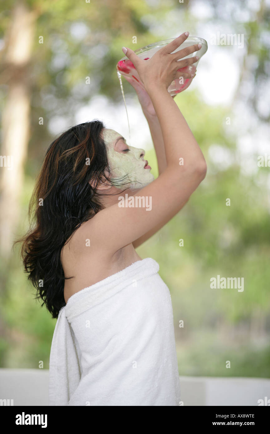 Side profile of a young woman pouring water on her head Stock Photo Alamy