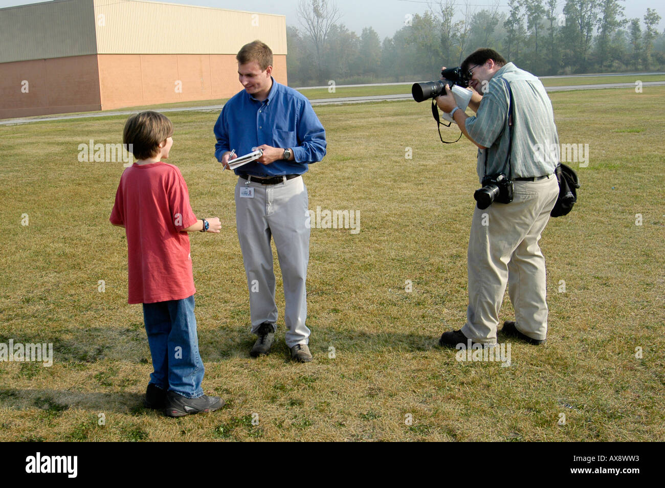 Newspaper reporter interviews a Middle School boy student Stock Photo