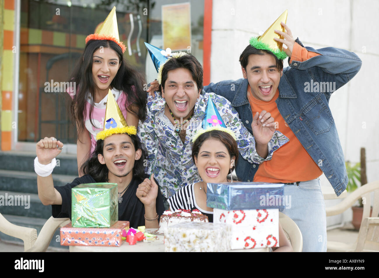 Portrait of teenage friends celebrating birthday party at a restaurant Stock Photo