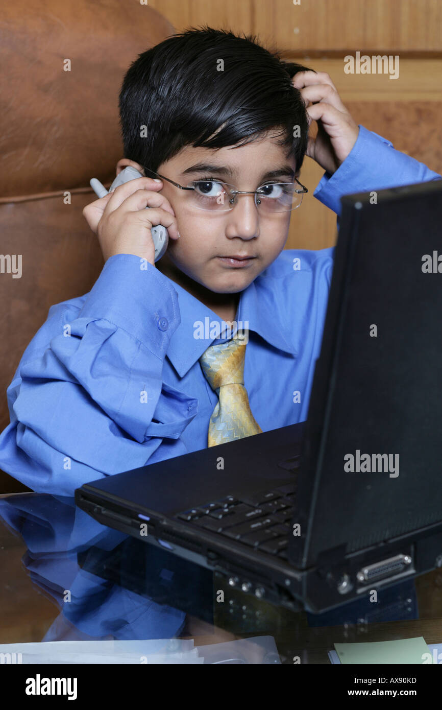 Boy imitating like a businessman and looking confused Stock Photo