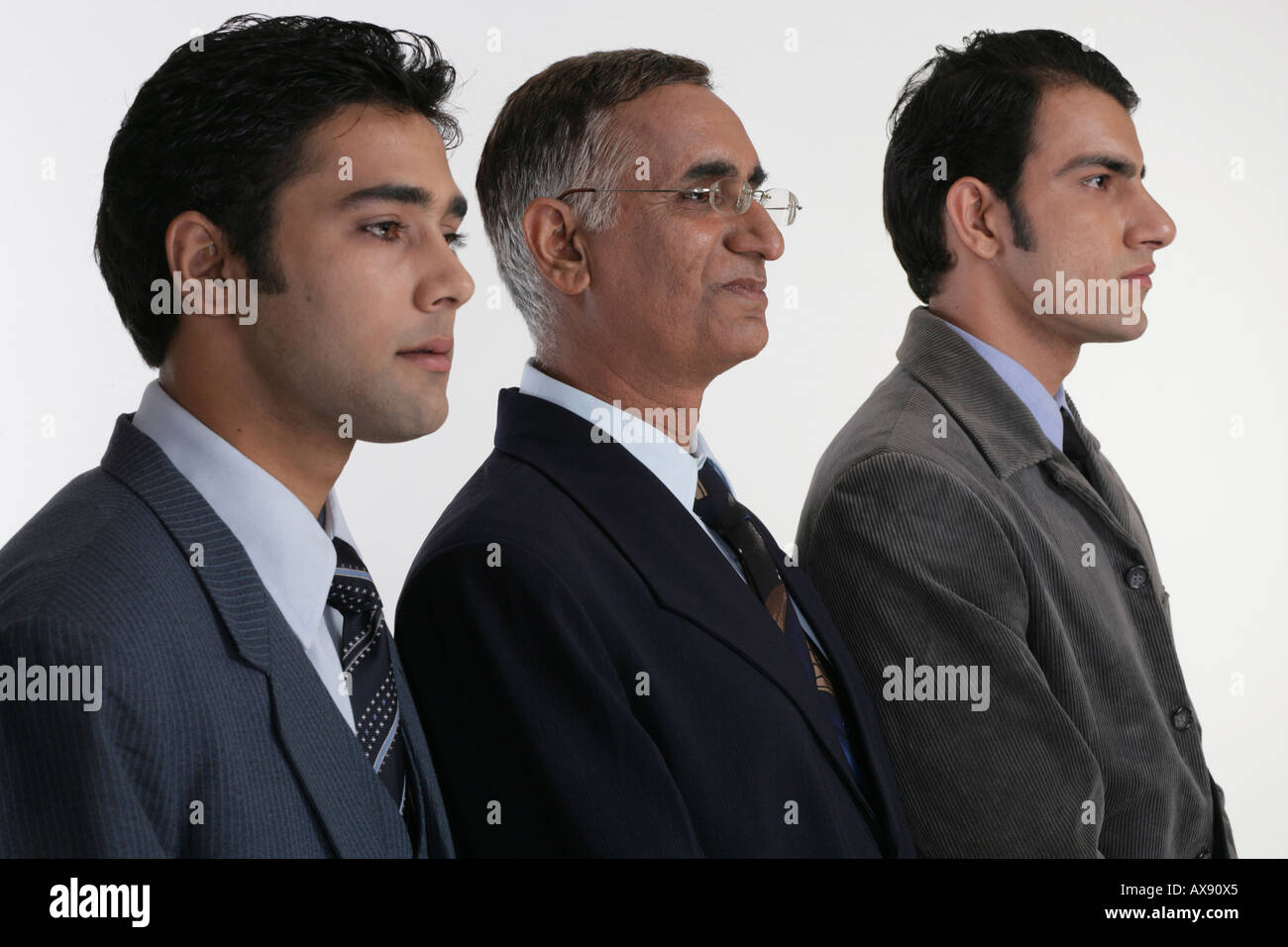 Side profile of three businessmen standing in a queue Stock Photo - Alamy