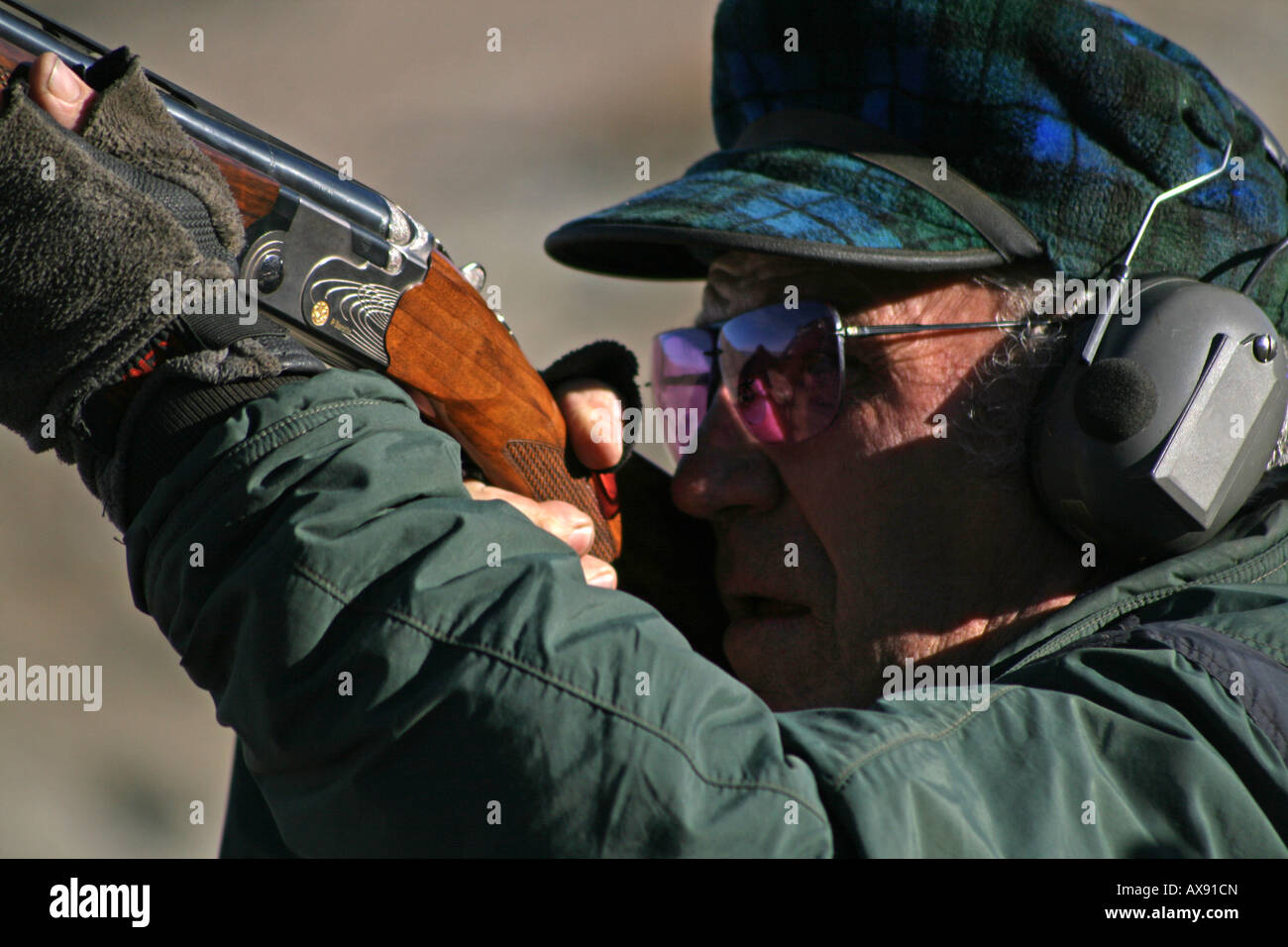 Closeup man shooting shotgun wearing hires stock photography and