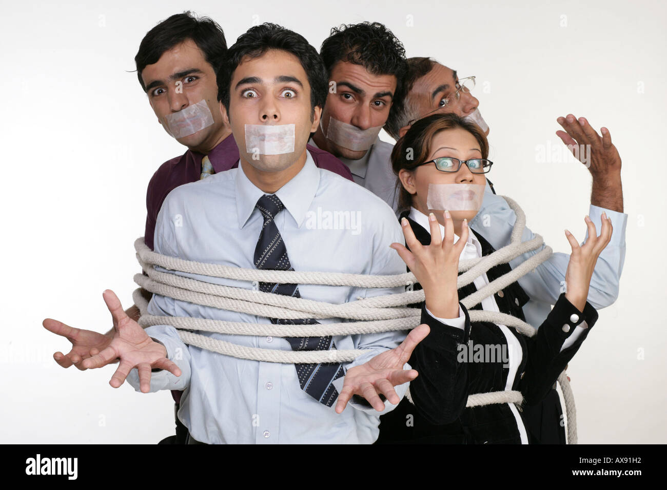 Portrait of five business people tied up with ropes Stock Photo