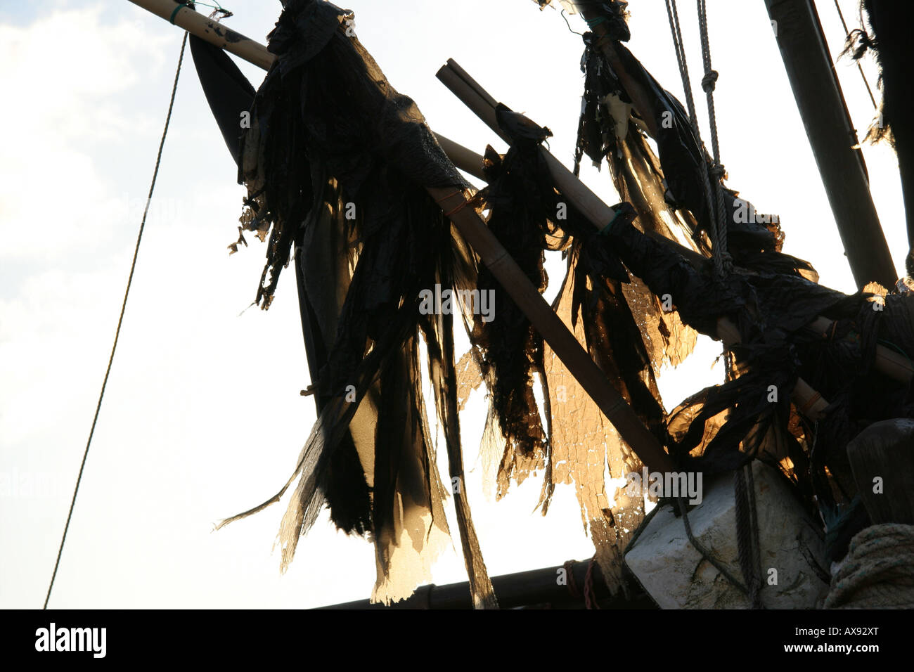 Torn black flags on boat Stock Photo