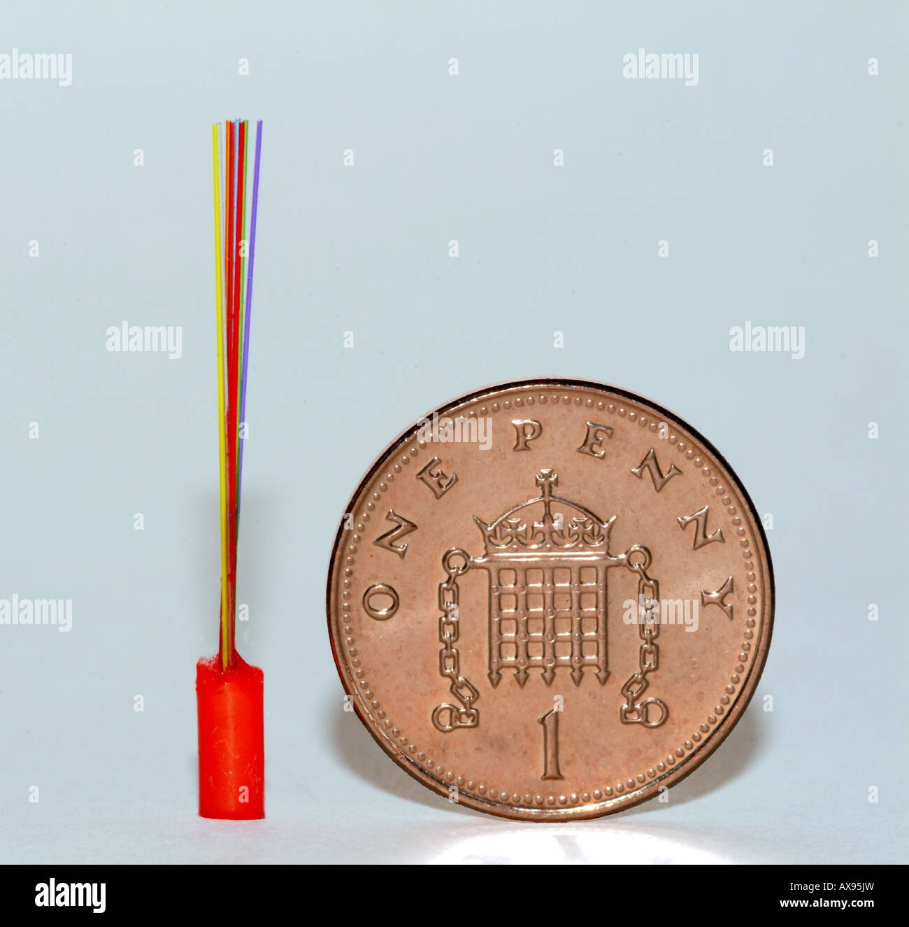 Optical fibres beside penny for scale Stock Photo