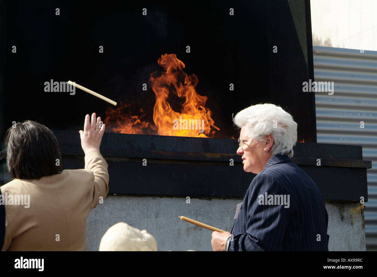 People throwing candles to the fire in Fátima Sanctuary in Portugal