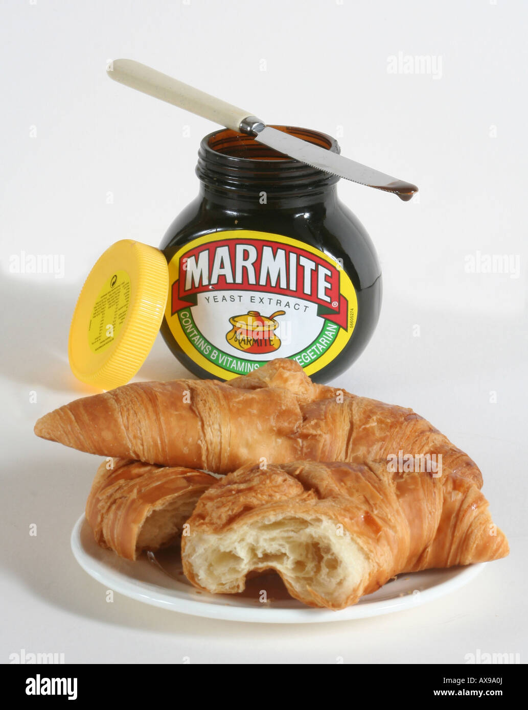 Marmite Jar and Plate of croissants Anglo French Food Stock Photo