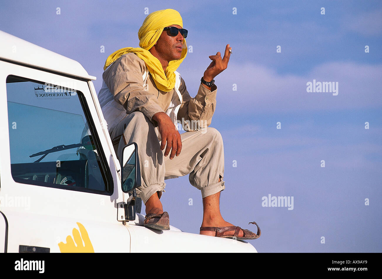 Chauffeur sitting on a jeep, Jeep Tour, Salt Desert, Chott el Djerid, Tunesia Stock Photo