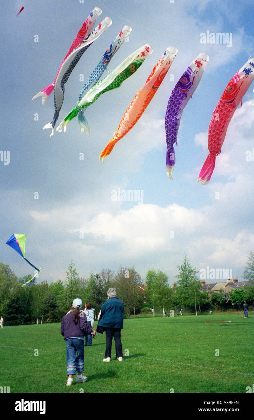 people flying kites in park Stock Photo