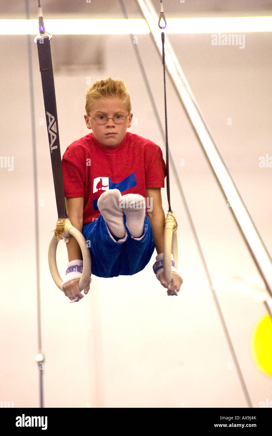 Boy performs on gymnastic rings during demonstration meet at U S