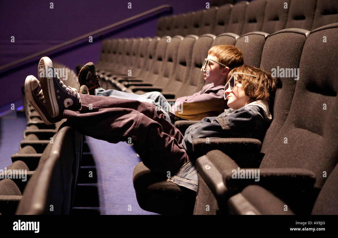 Two boys watching an Imax movie, with 3D glasses on Stock Photo - Alamy