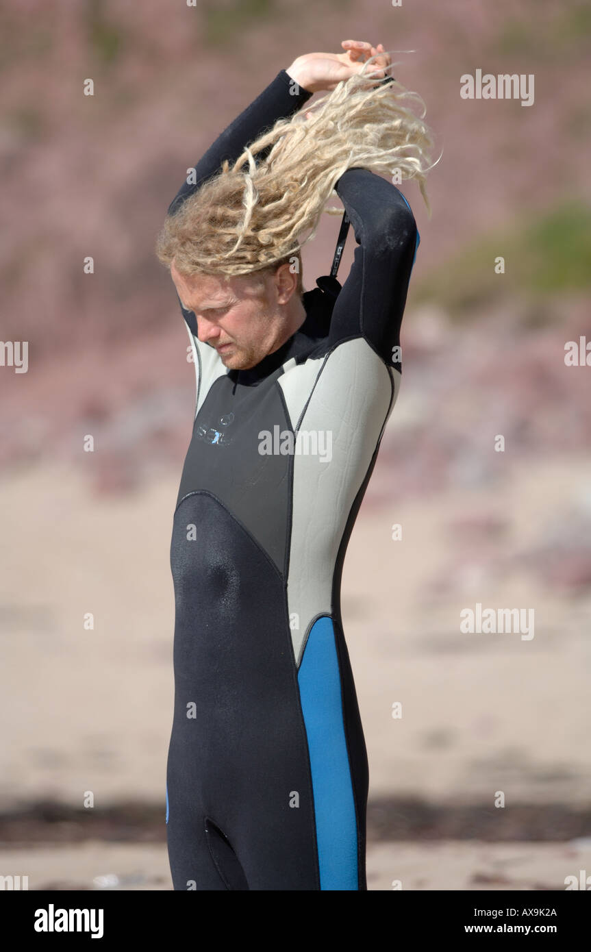 Surfer putting on wetsuit West Dale Stock Photo Alamy