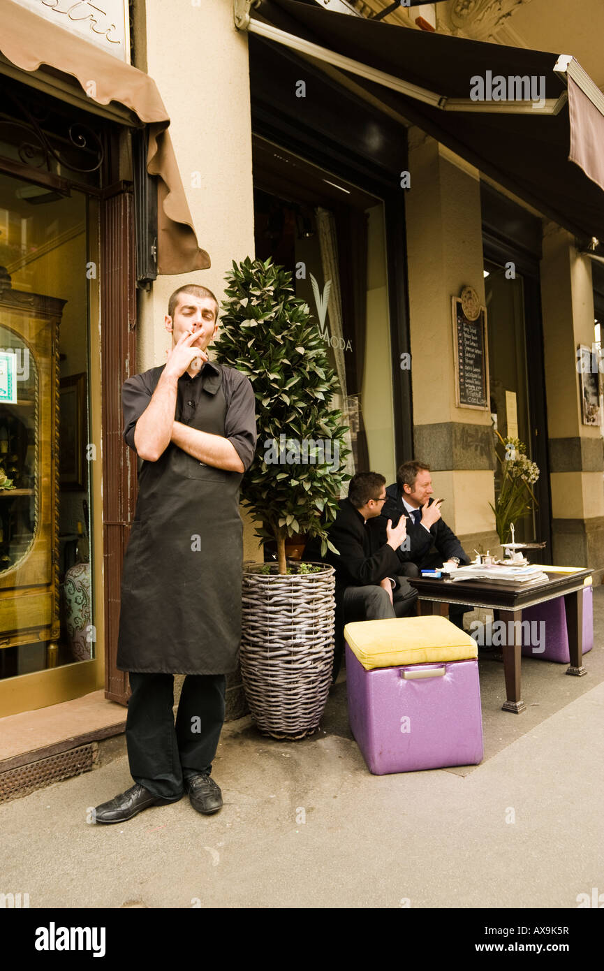 A WAITER TAKES A CIGARETTE BREAK MILAN ITALY Stock Photo