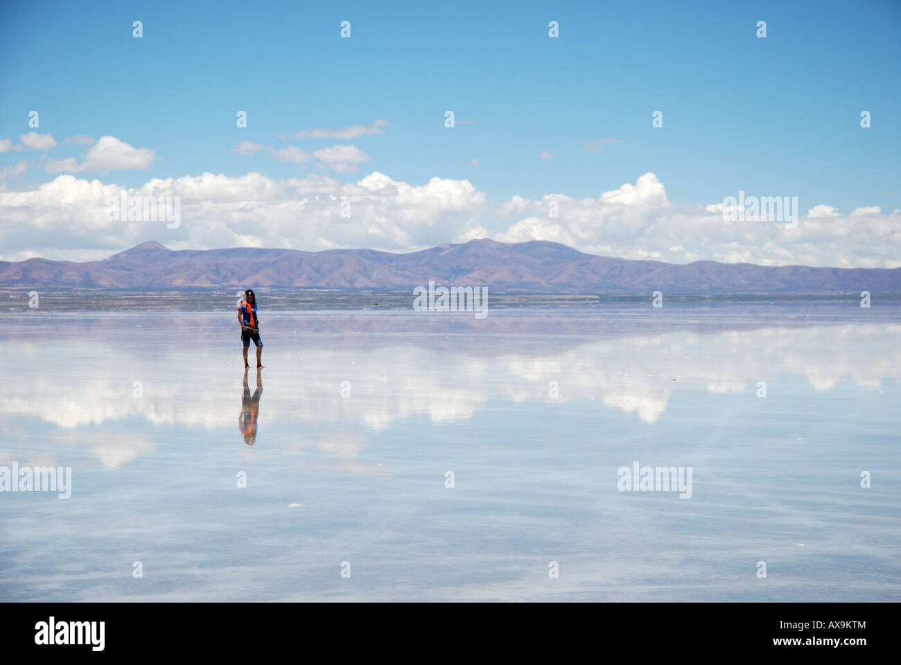 Reflected silhouettes of tourists on the Salt Flats of Uyuni, Bolivia, South America Stock Photo