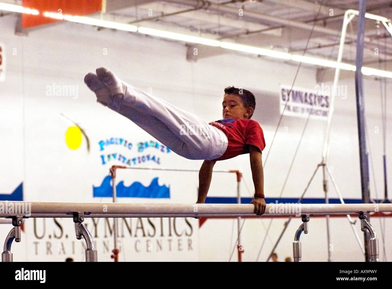 Boy performs on gymnastics parallel bars during demonstration meet at U S Gymnastics Center in California USA Stock Photo