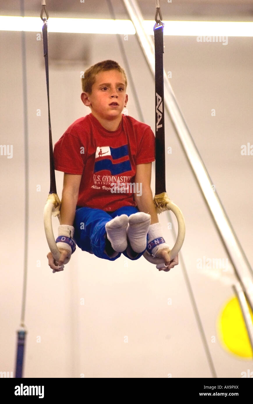 Boy performs on gymnastic rings during demonstration meet at U S
