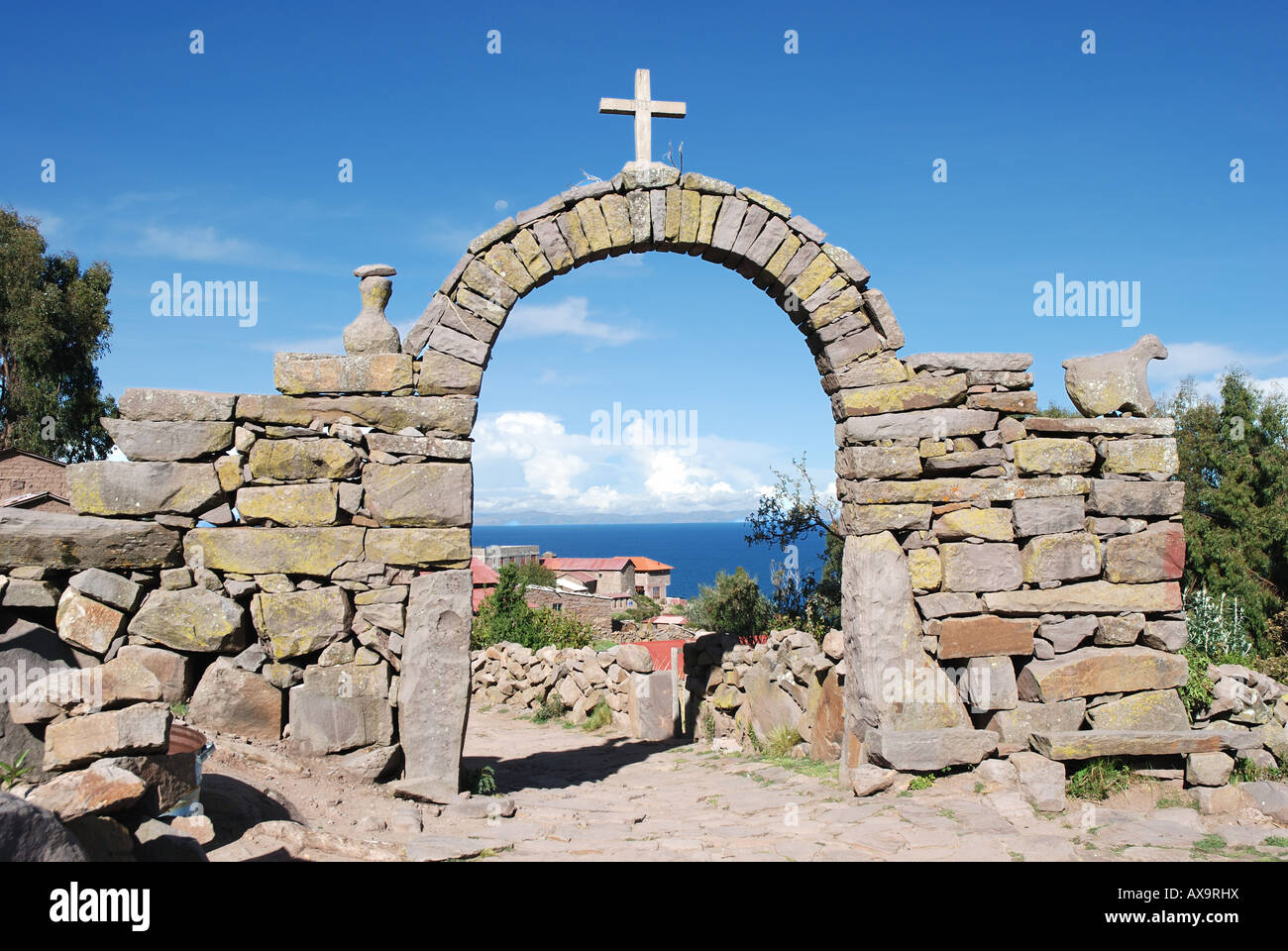 Stone arch with cross on the island of Taquile in Lake Titicaca off the coast of Puno, Peru Stock Photo