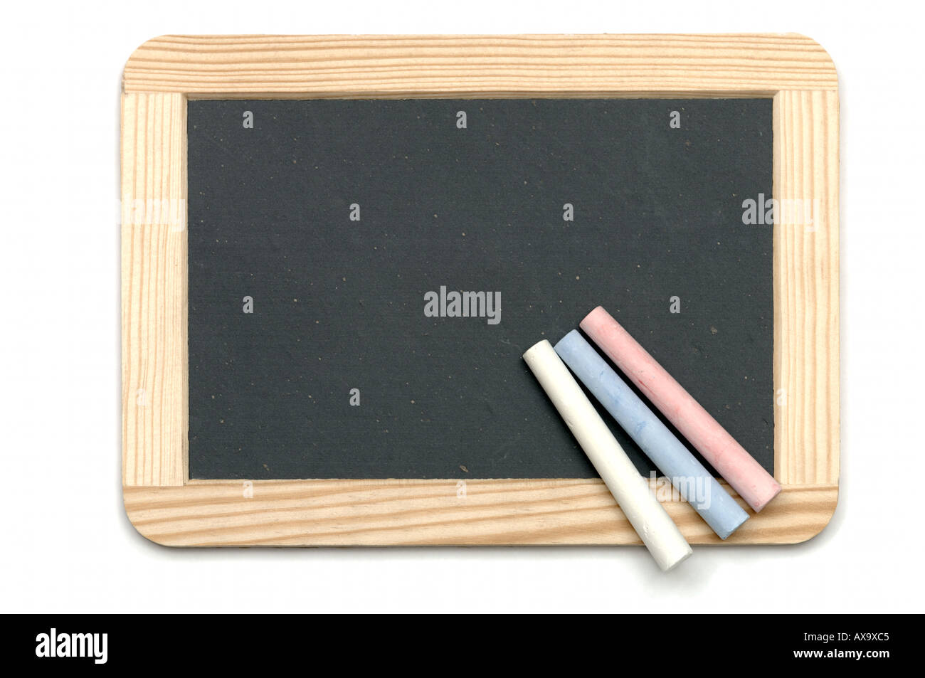 Chalk sticks on blank writing traditional slate in wooden frame on white background Stock Photo