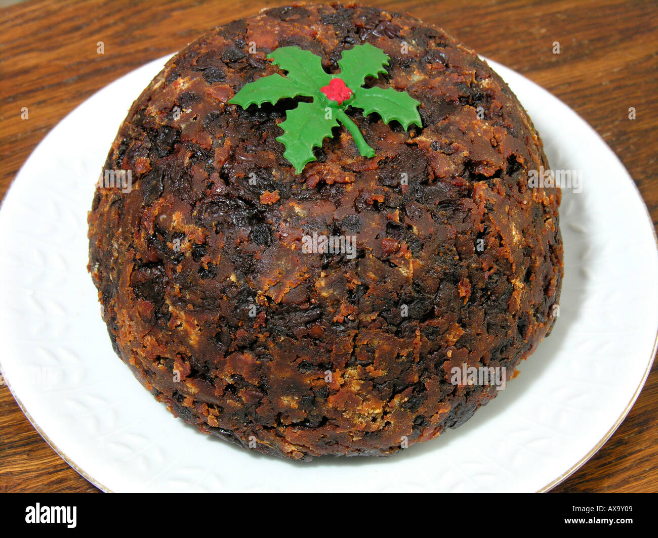 Christmas pudding with a sprig of holly Stock Photo