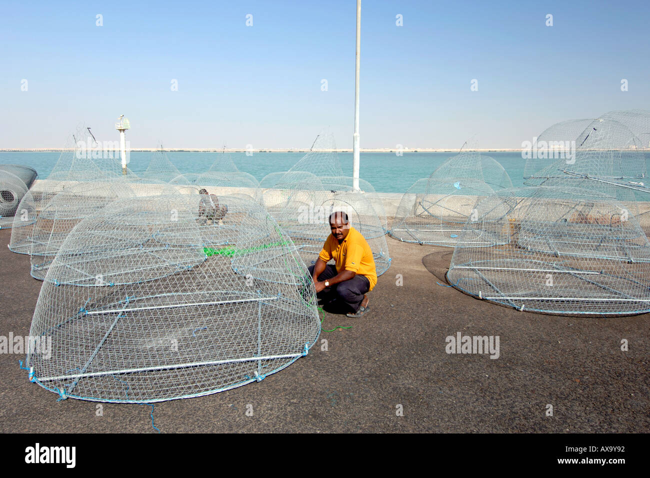 A fisherman preparing his nets in the harbour of the Al Khor fishing