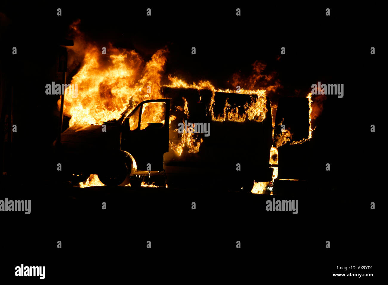 Van burning as roadblock during loyalist rioting and violence north belfast northern ireland Stock Photo