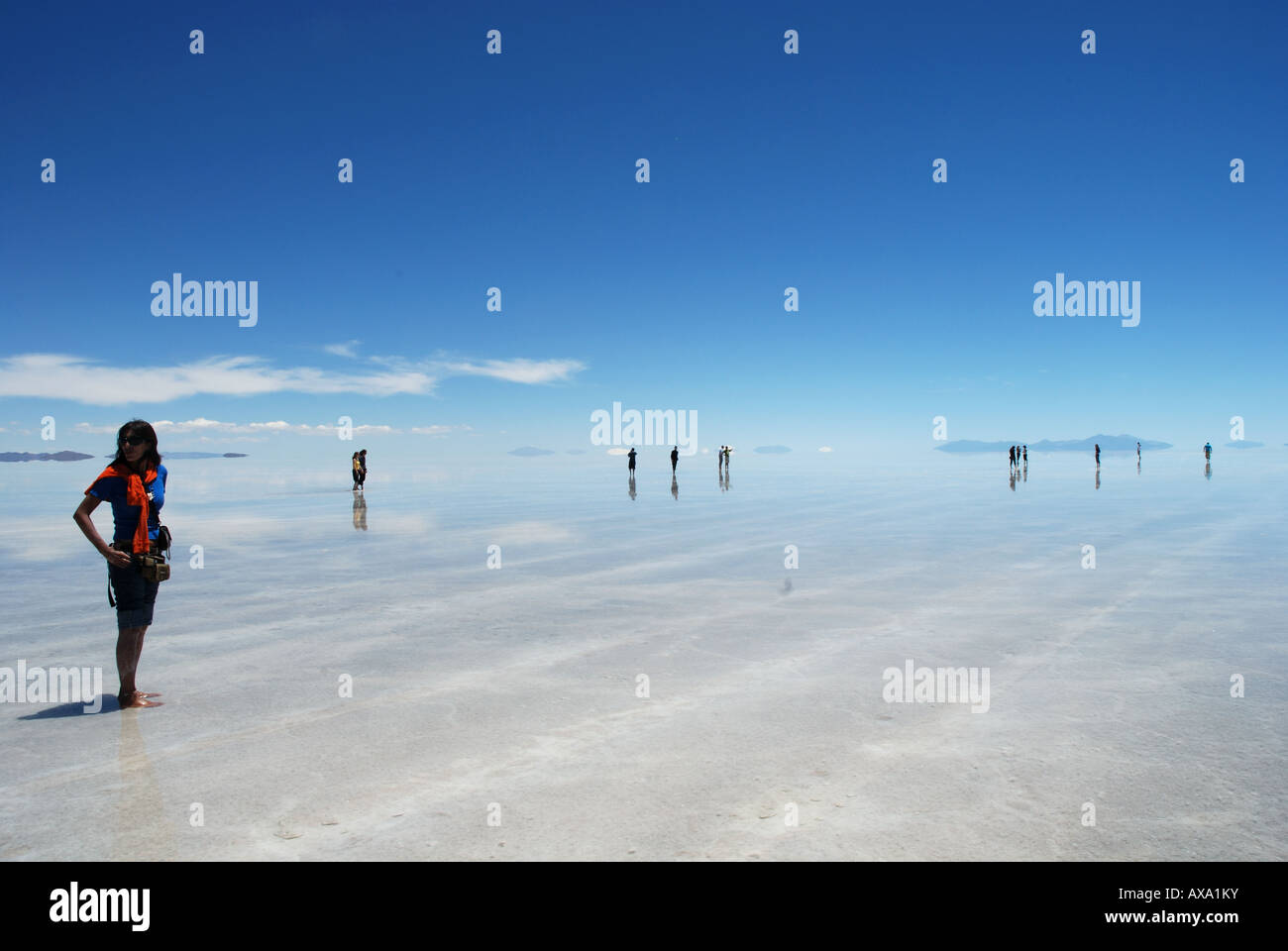 Silhouettes of tourists on the Salt Flats of Uyuni, Bolivia, South America Stock Photo