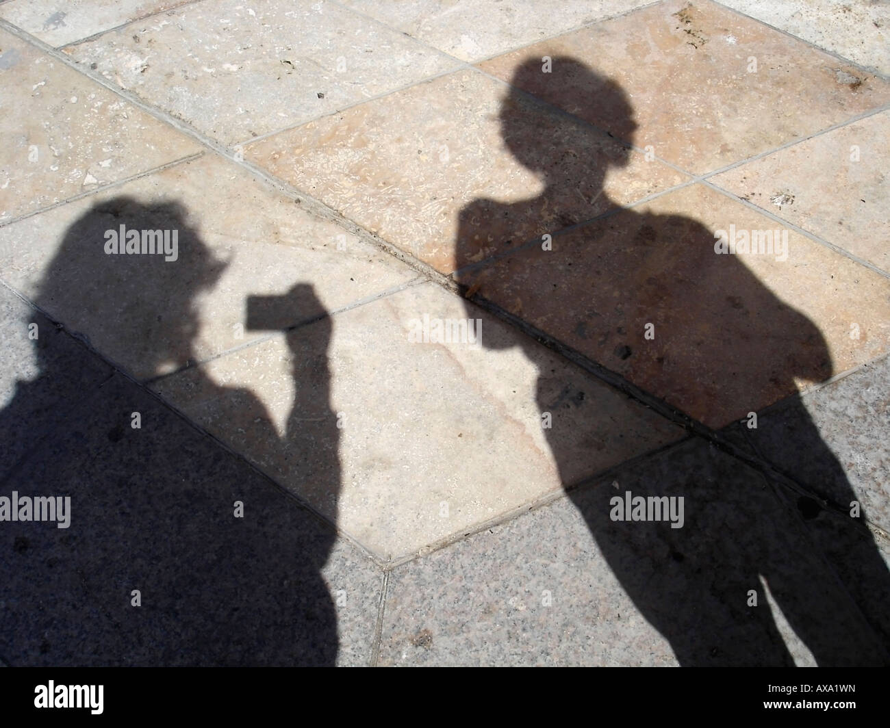 Shadows or silhouettes of two women on a stone tile floor Stock Photo ...