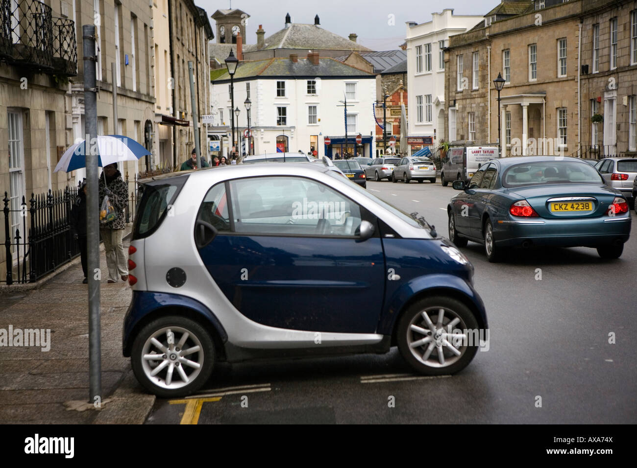 A 'Smart' car parked sideways in a parking bay in Lemon Street, Cornwall Stock Photo