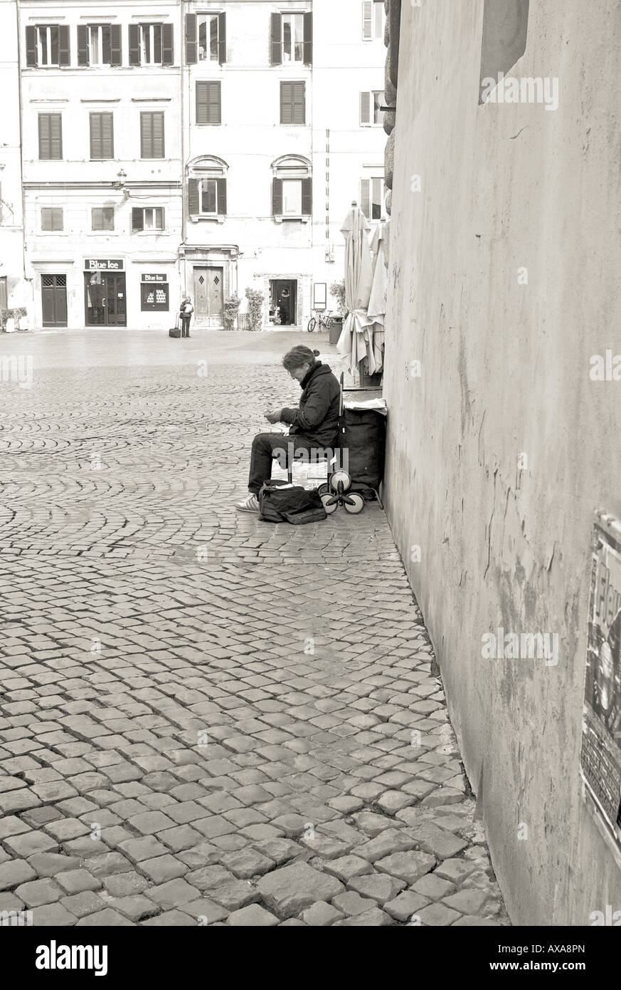 Rome Street woman sitting down in the street Stock Photo