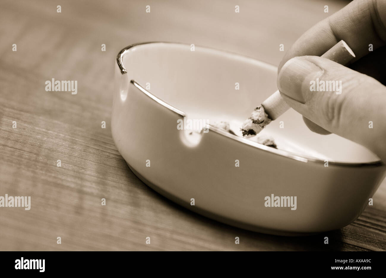 putting out a cigarette in an ashtray Stock Photo Alamy