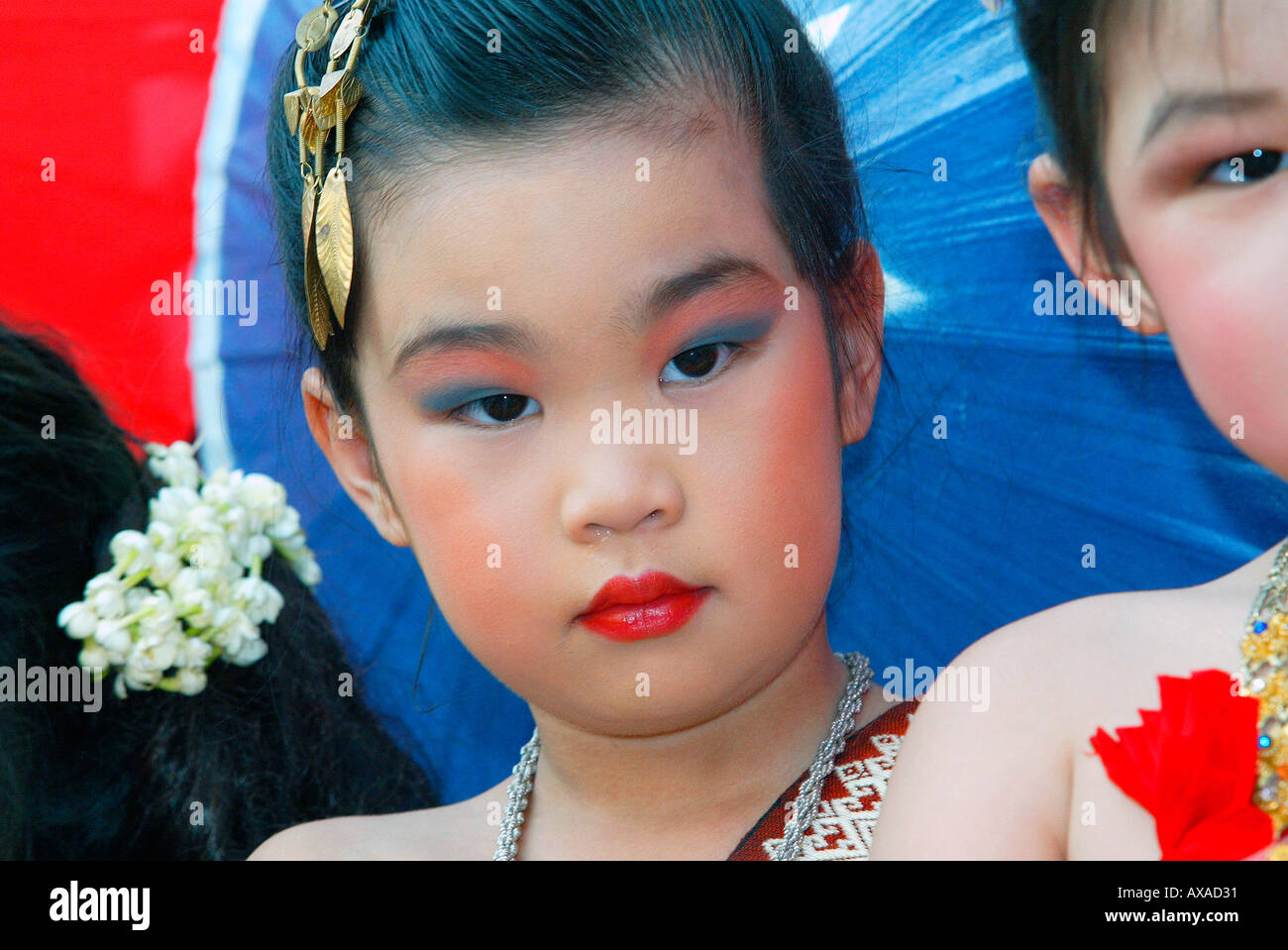 Young girl in parade at Bo Sang Umbrella Festival near Chiang Mai north Thailand Stock Photo