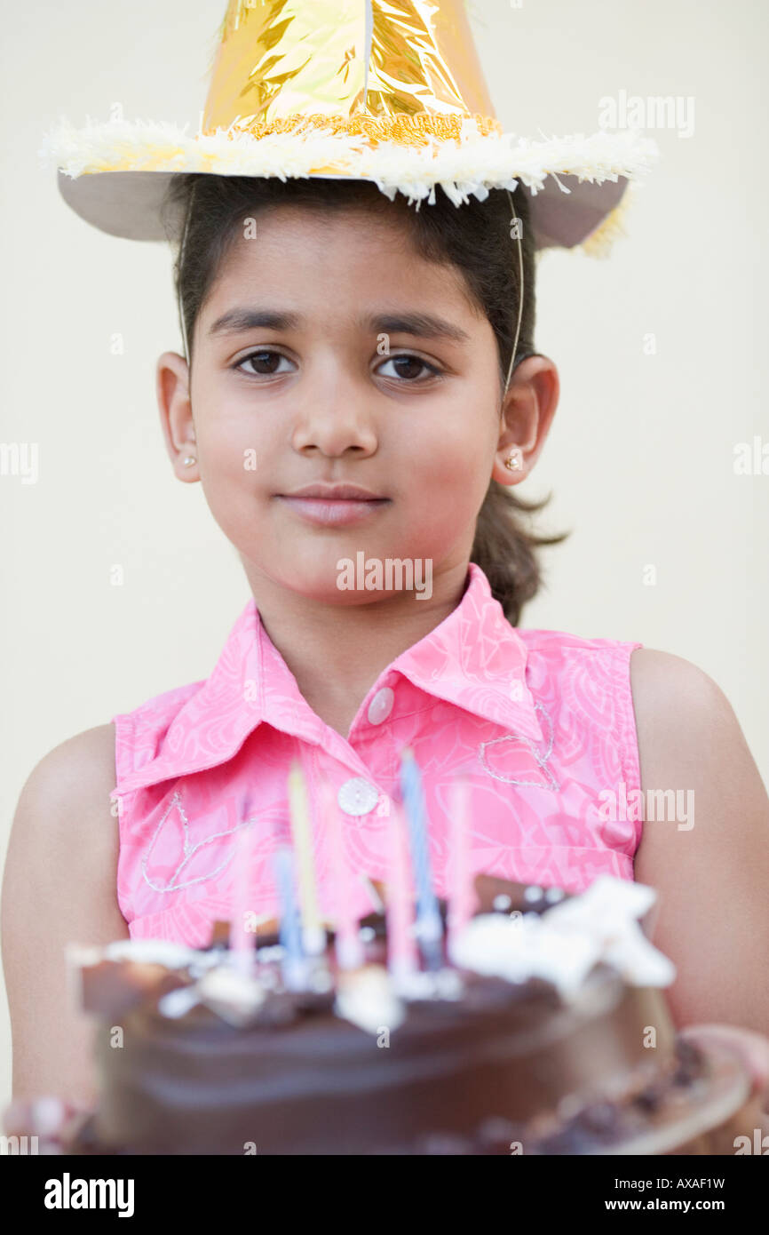 Portrait of a girl holding a birthday cake and smiling Stock Photo - Alamy