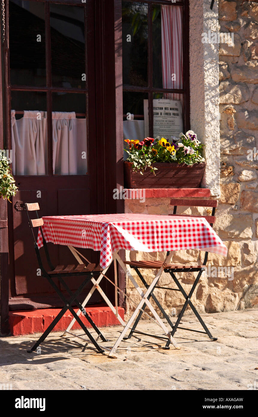 Table and chairs outside cafe in Barbizon France Stock Photo
