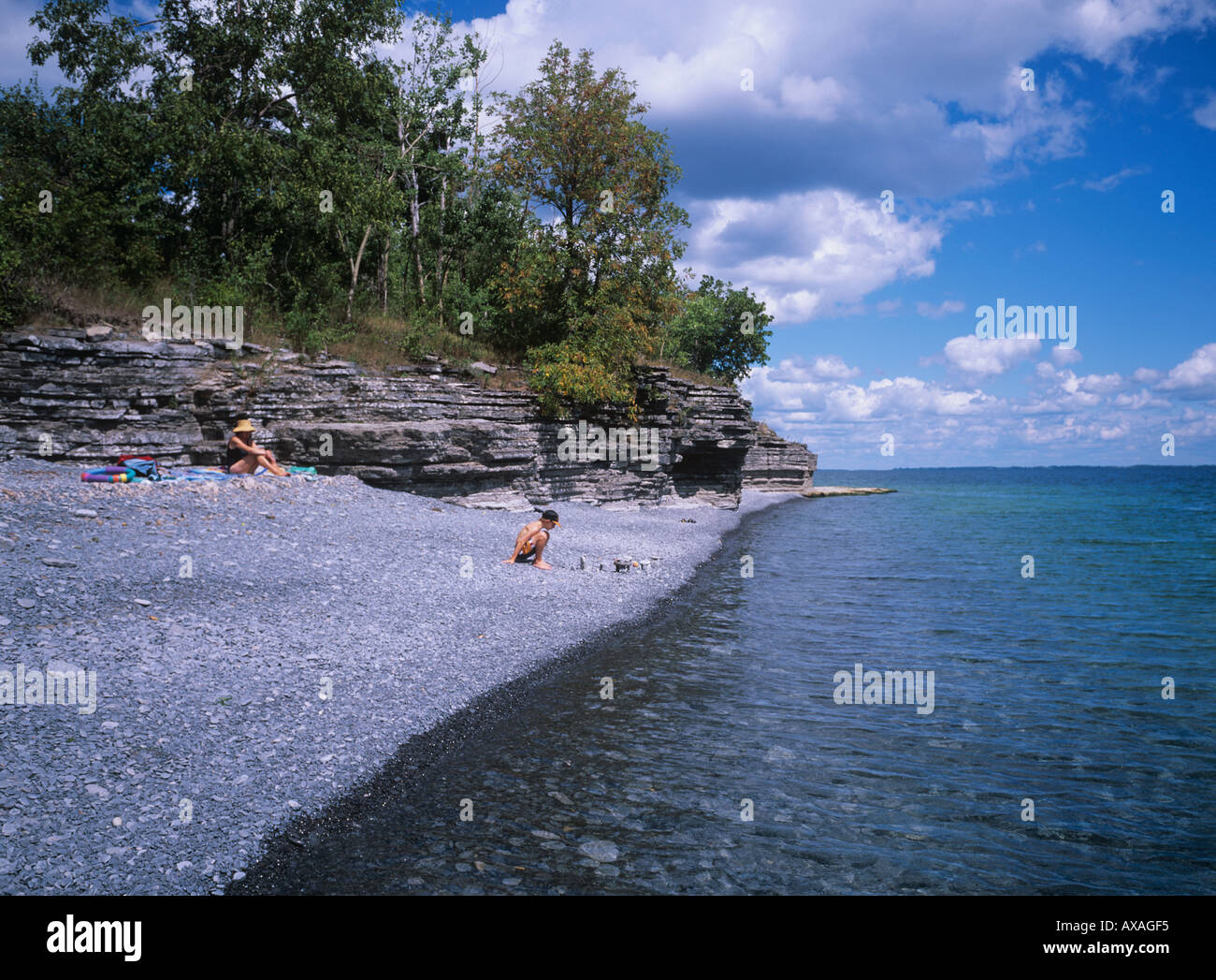 Secluded pebble beach with small limestone cliffs Crystal clear water