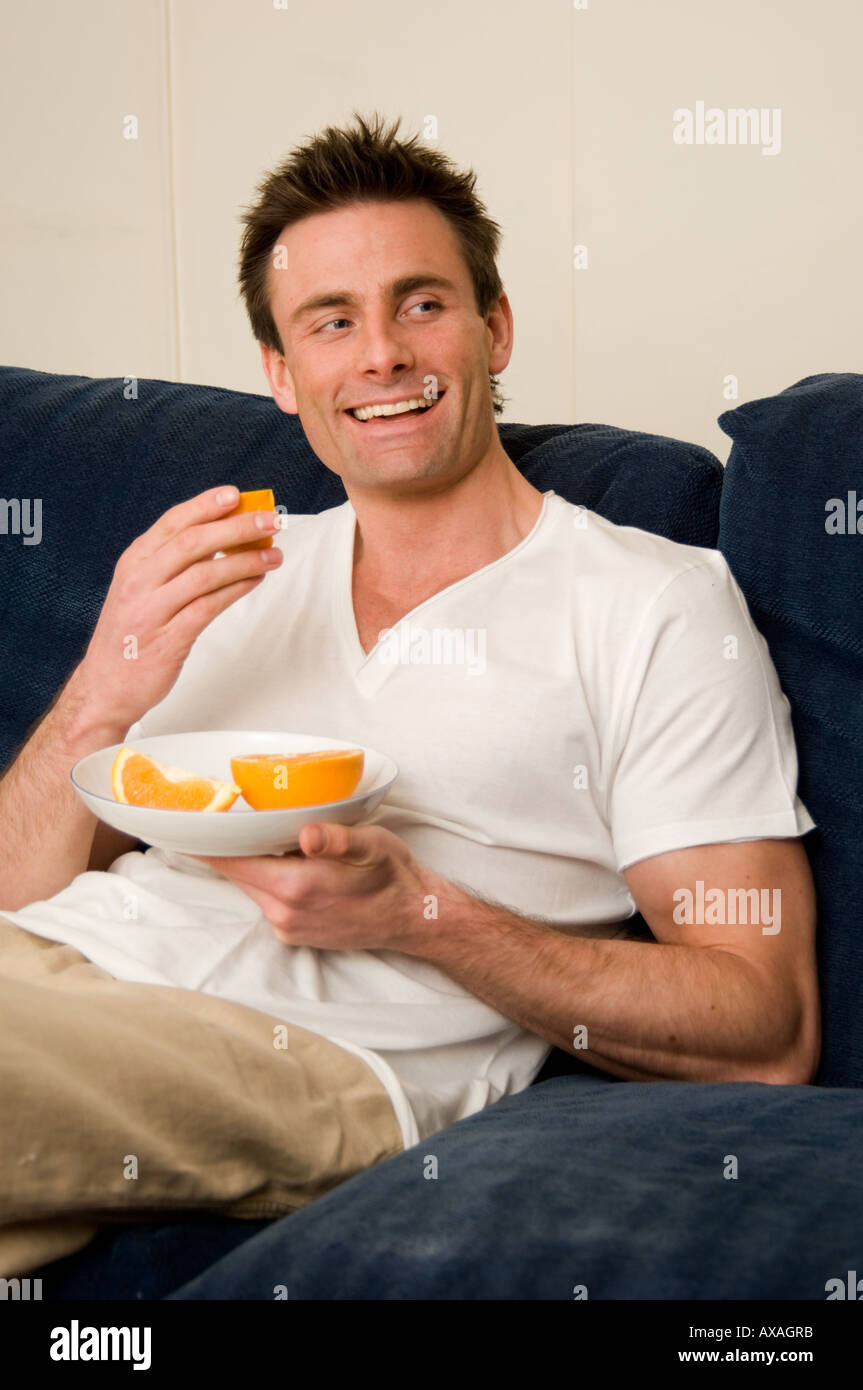 man eating oranges Stock Photo Alamy