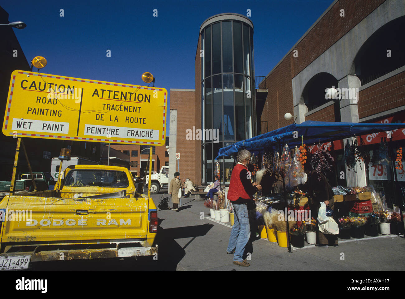 Warning sign in French and English near the Ottawa market Yellow truck with big signs CANADA Stock Photo