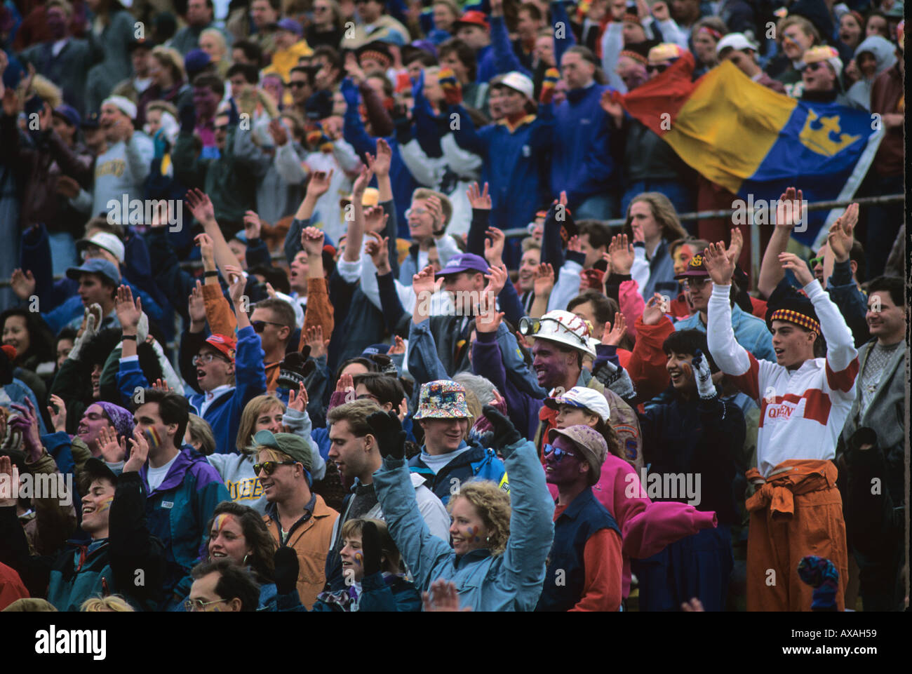 Queens University Students at a football match wear faculty colours face paint Kingston Ontario