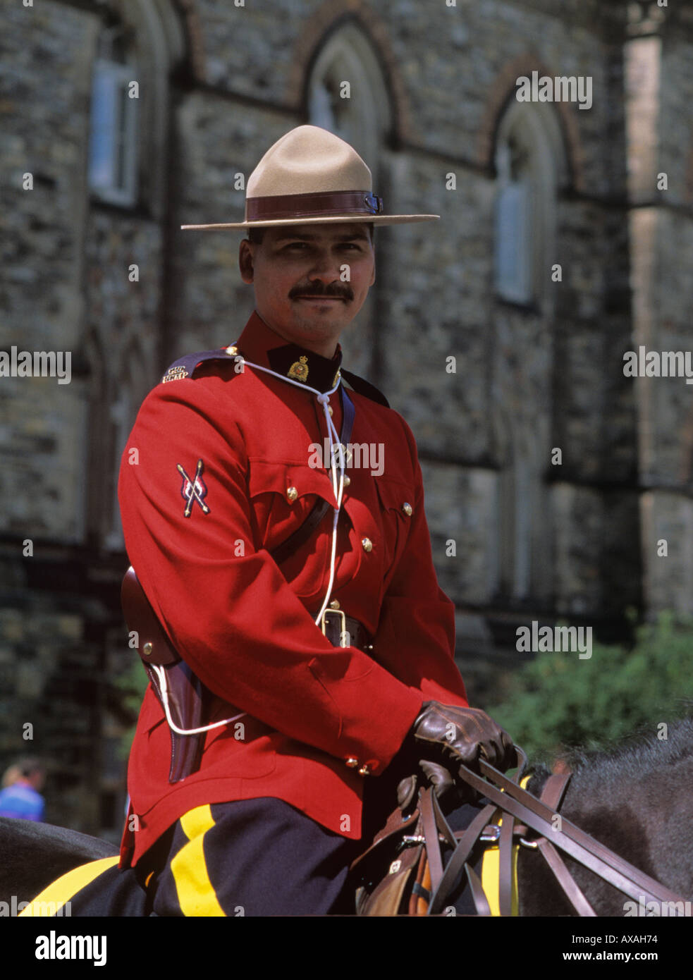 Handsome Mountie in red ceremonial uniform stands guard outside Ottawa Parliament buildings Ontario CANADA Stock Photo