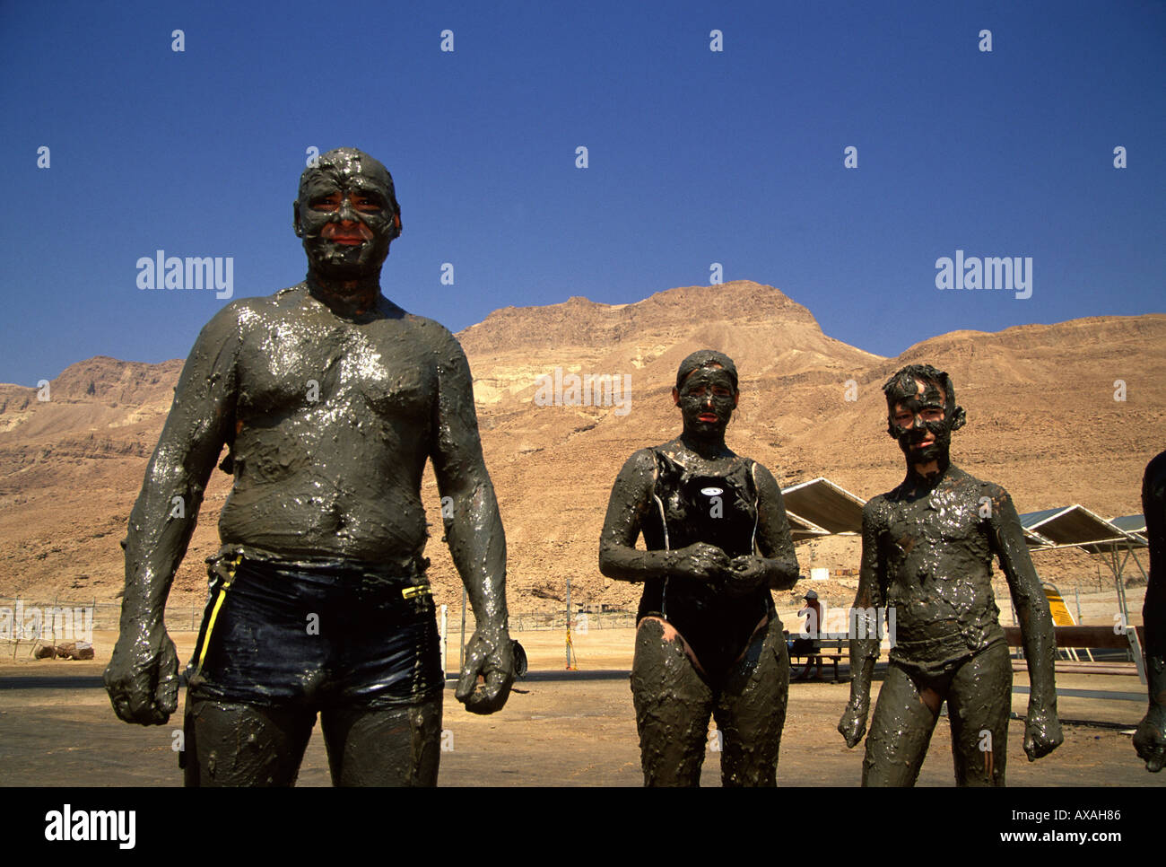 People smeared with natural black mud from the Dead Sea at Ein Gedi Sea