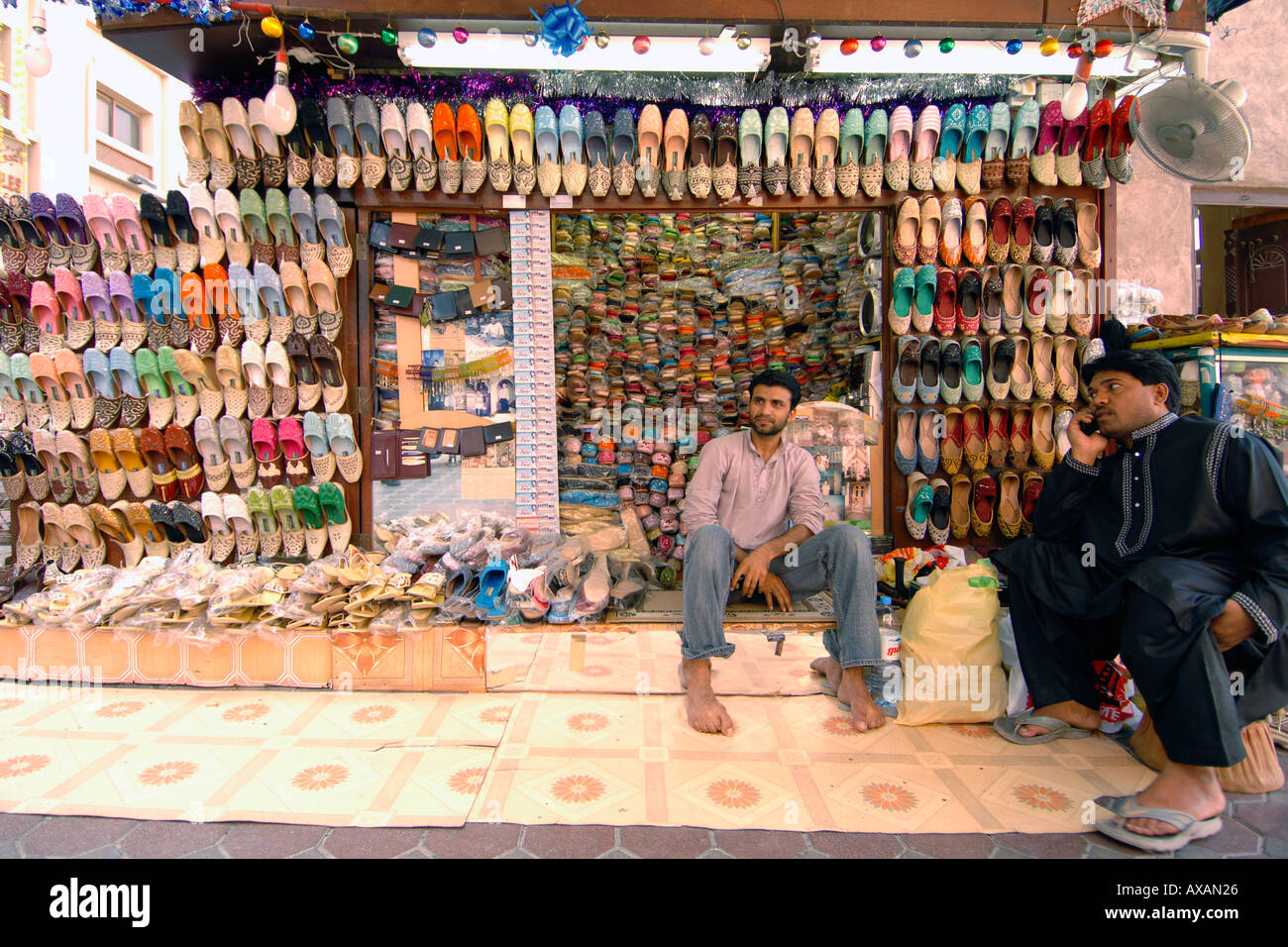 A shoe vendor and his shoe stall in the Dubai souk Stock Photo Alamy