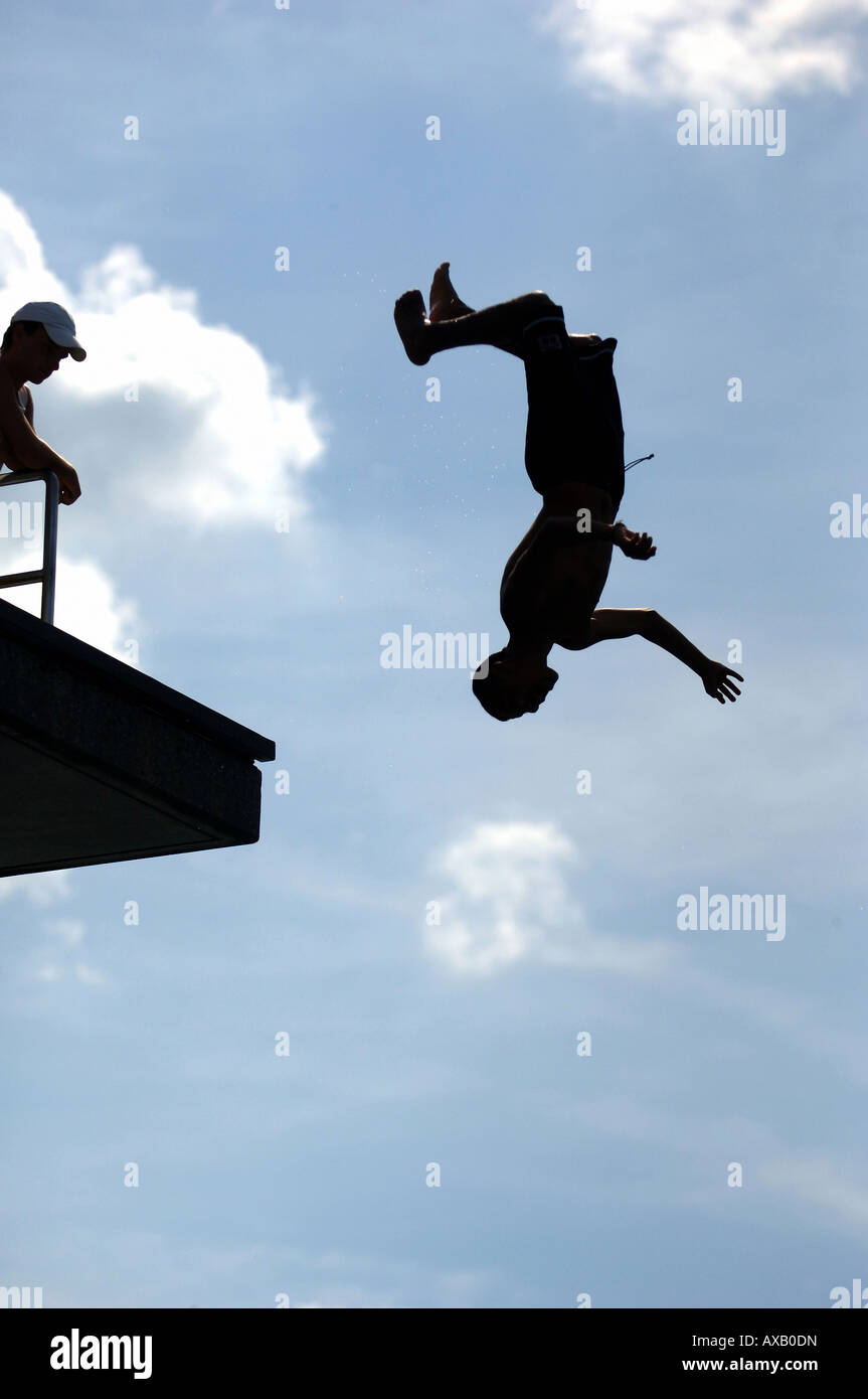 Man doing an upside down backward jump from a springboard Stock Photo