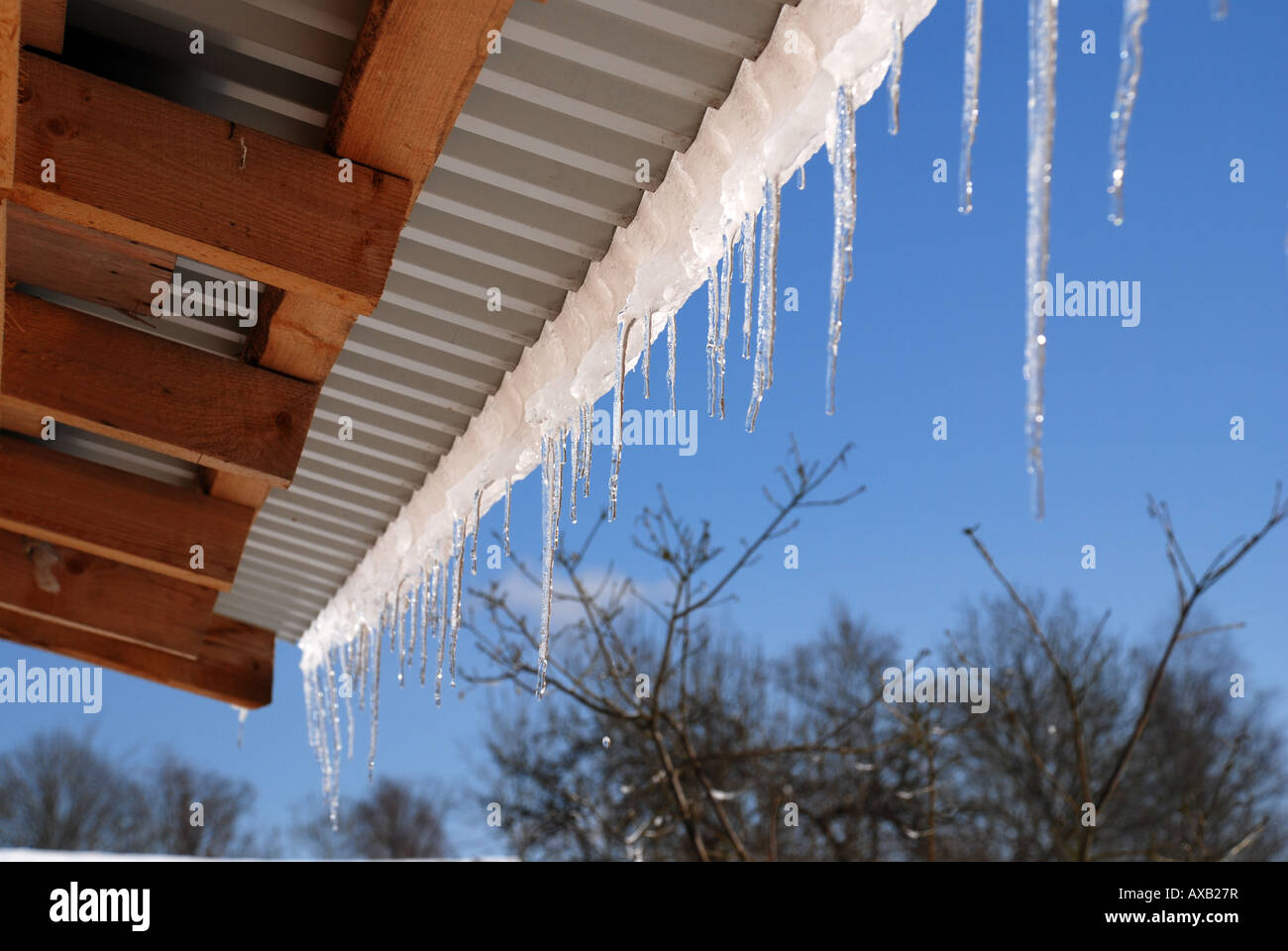 Icicles Hanging from Roof Stock Photo