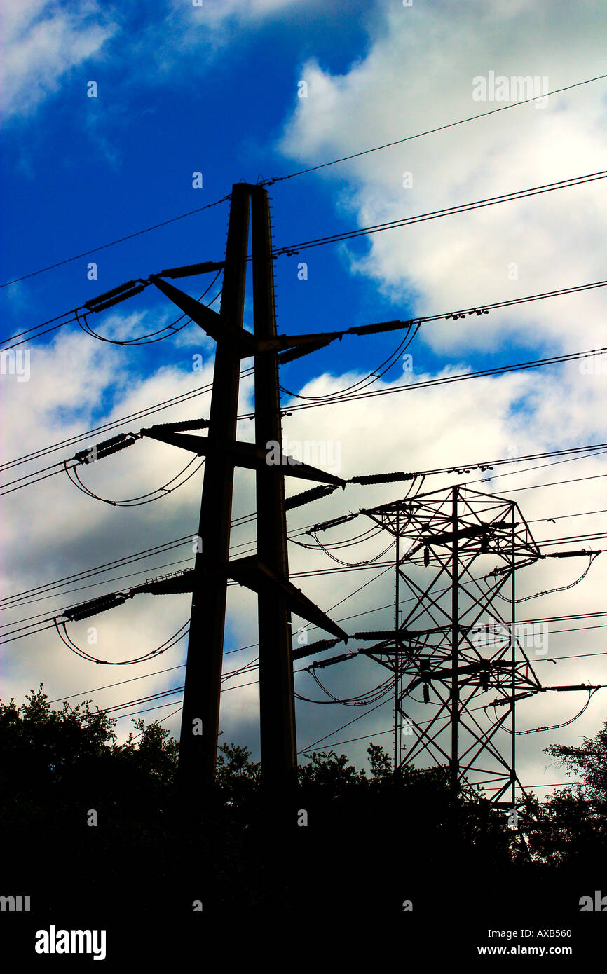Electrical Transmission Tower against a blue cloudy sky Stock Photo - Alamy