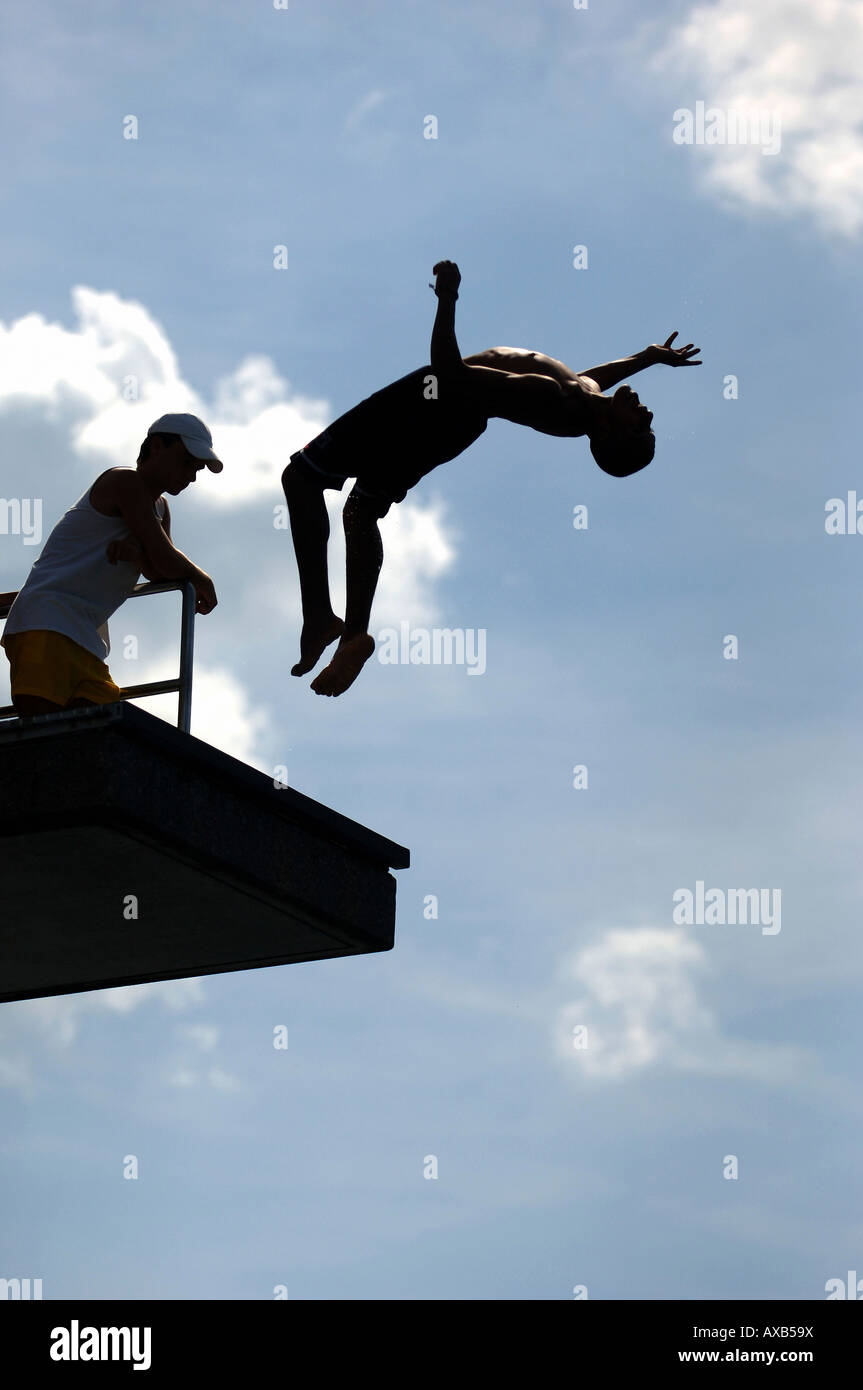 Man doing a backward jump from a springboard Stock Photo