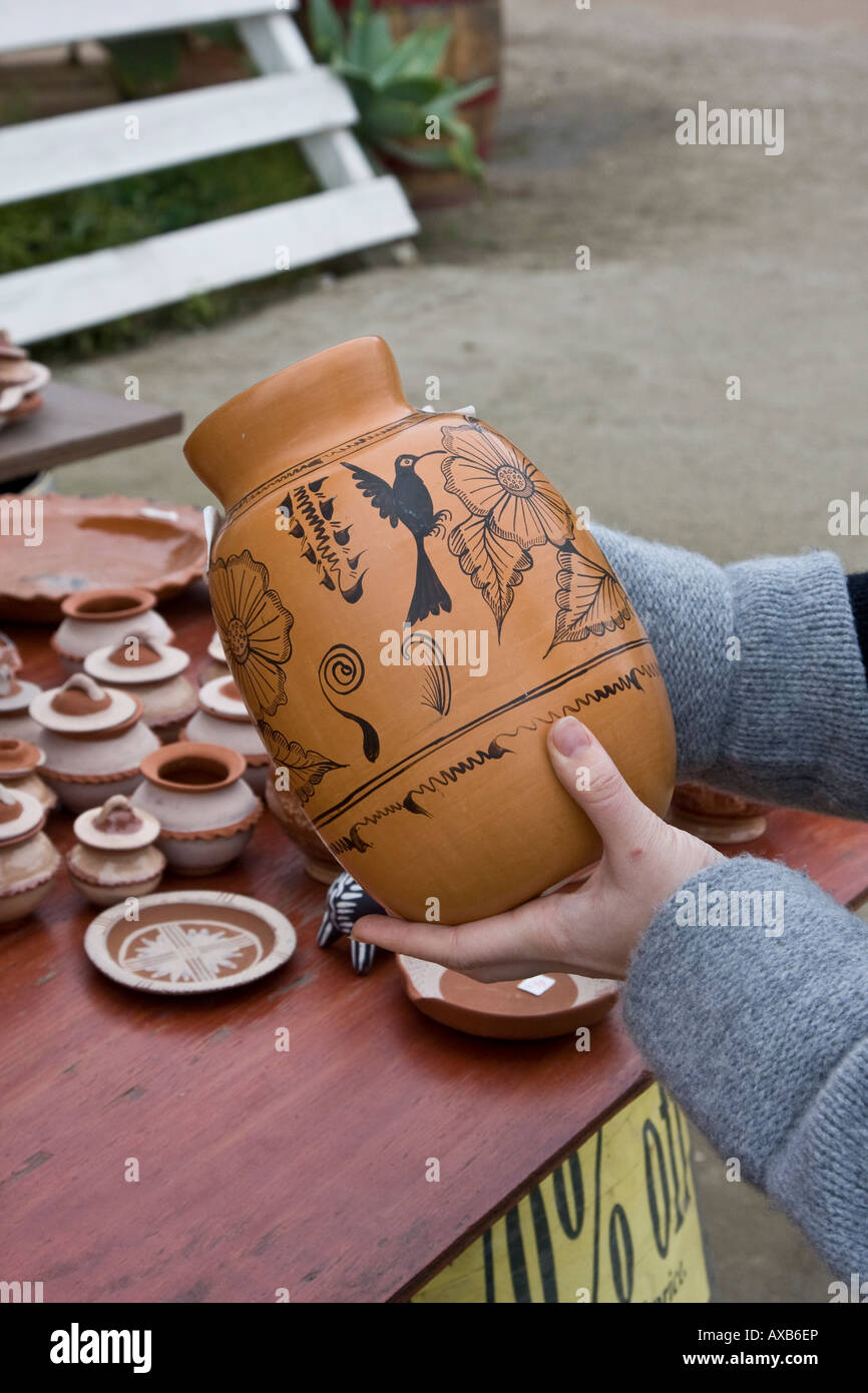 tourist checking traditionally handpainted vase in San Diego Stock Photo
