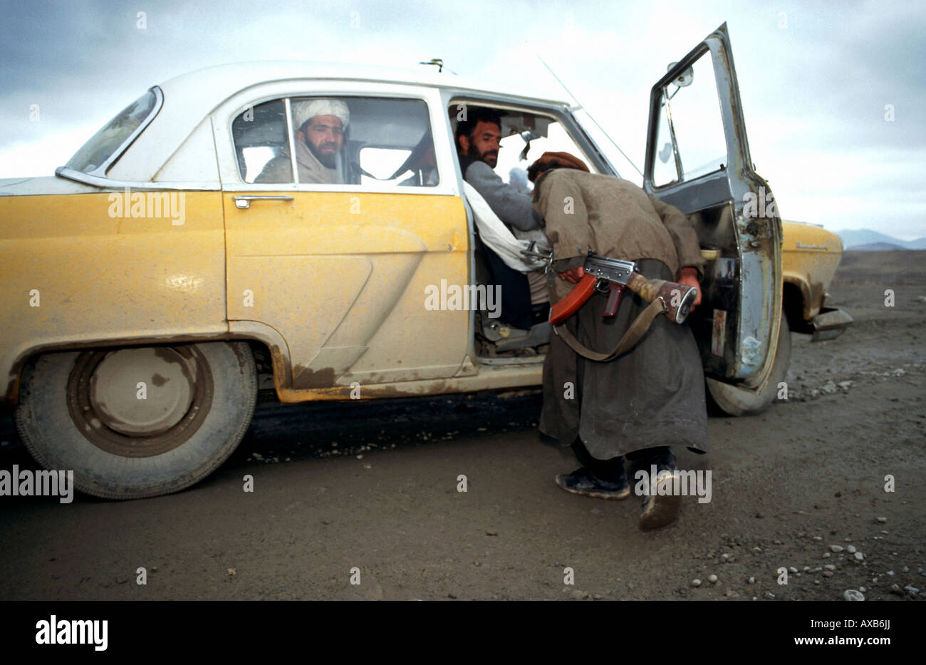 Solider inspecting a vehicle near the frontline, Kabul, Afghanistan Stock Photo