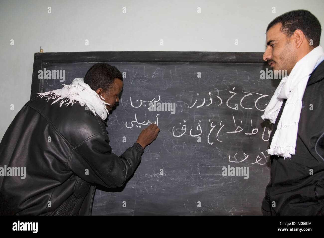 Egyptian teachers teach arabic writing on blackboard in classroom in Nubian village near Aswan Nubia Egypt North Africa Stock Photo