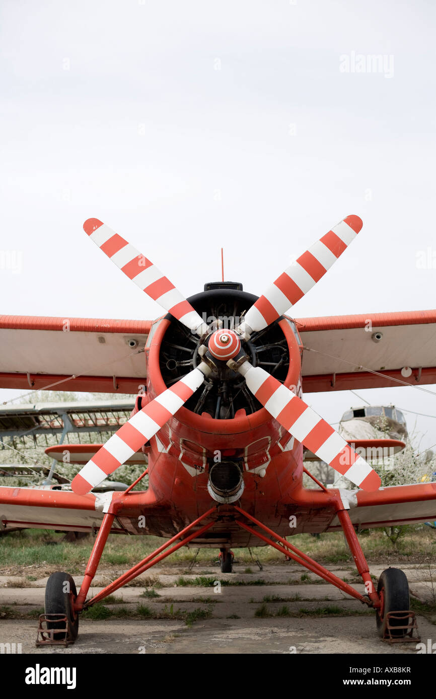 biplane airplane landed with its propeller raised above Stock Photo
